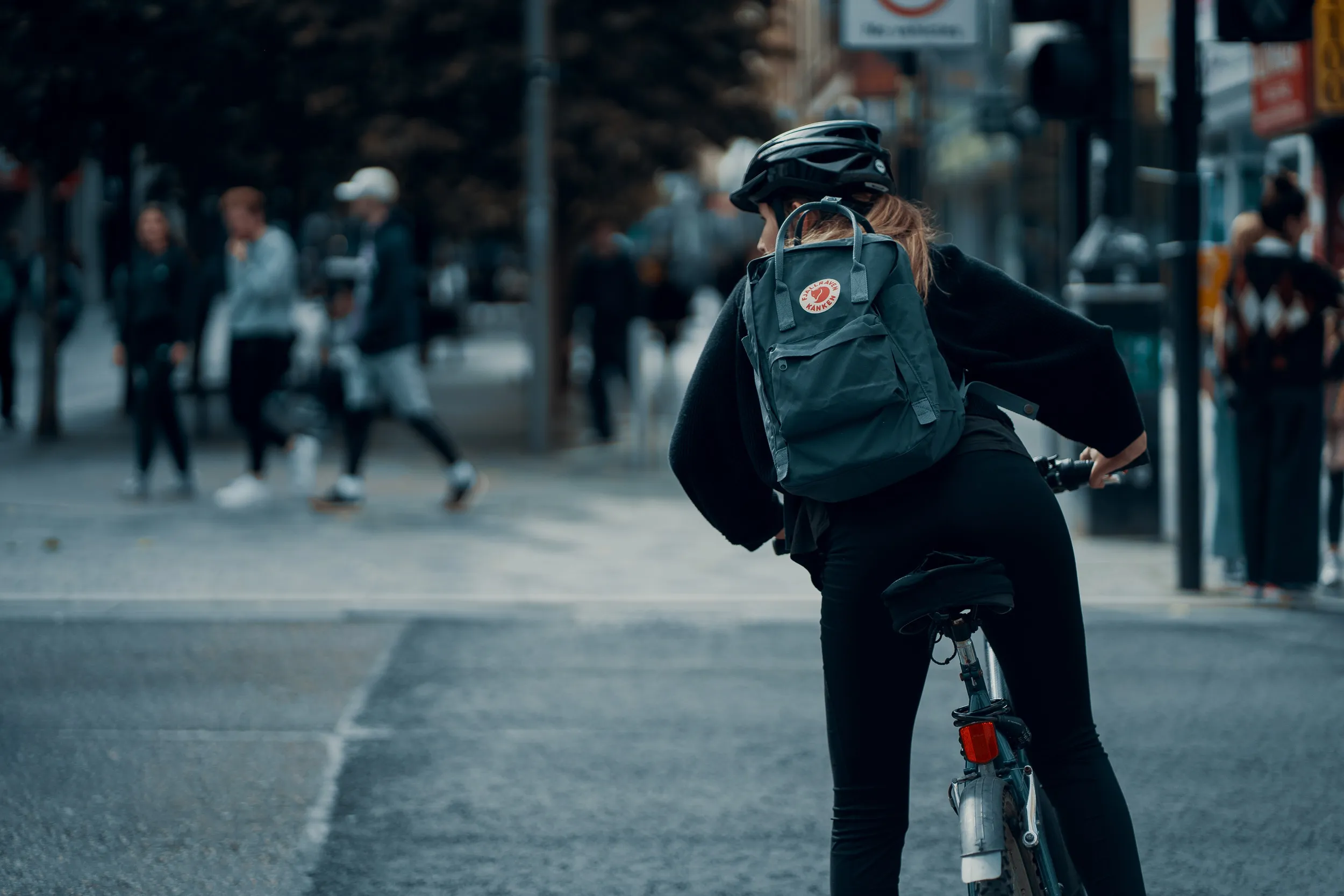 Cyclist commuting through urban traffic in Boston